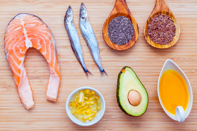 Selection food sources of omega 3 and unsaturated fats. Super food high vitamin e and dietary fiber for healthy food. Olive oil ,flax seed ,chia ,fish oil ,avocado ,shishamo fish and salmon on bamboo cutting board.